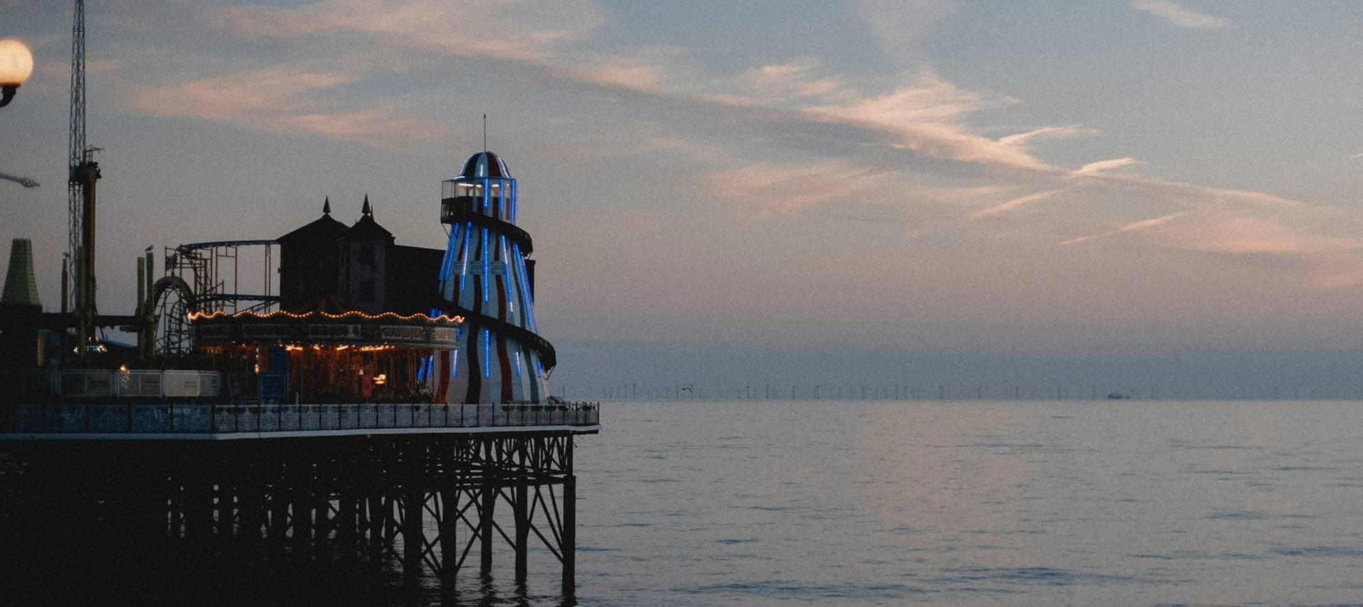 Picture of a pier with a wind farm in the background