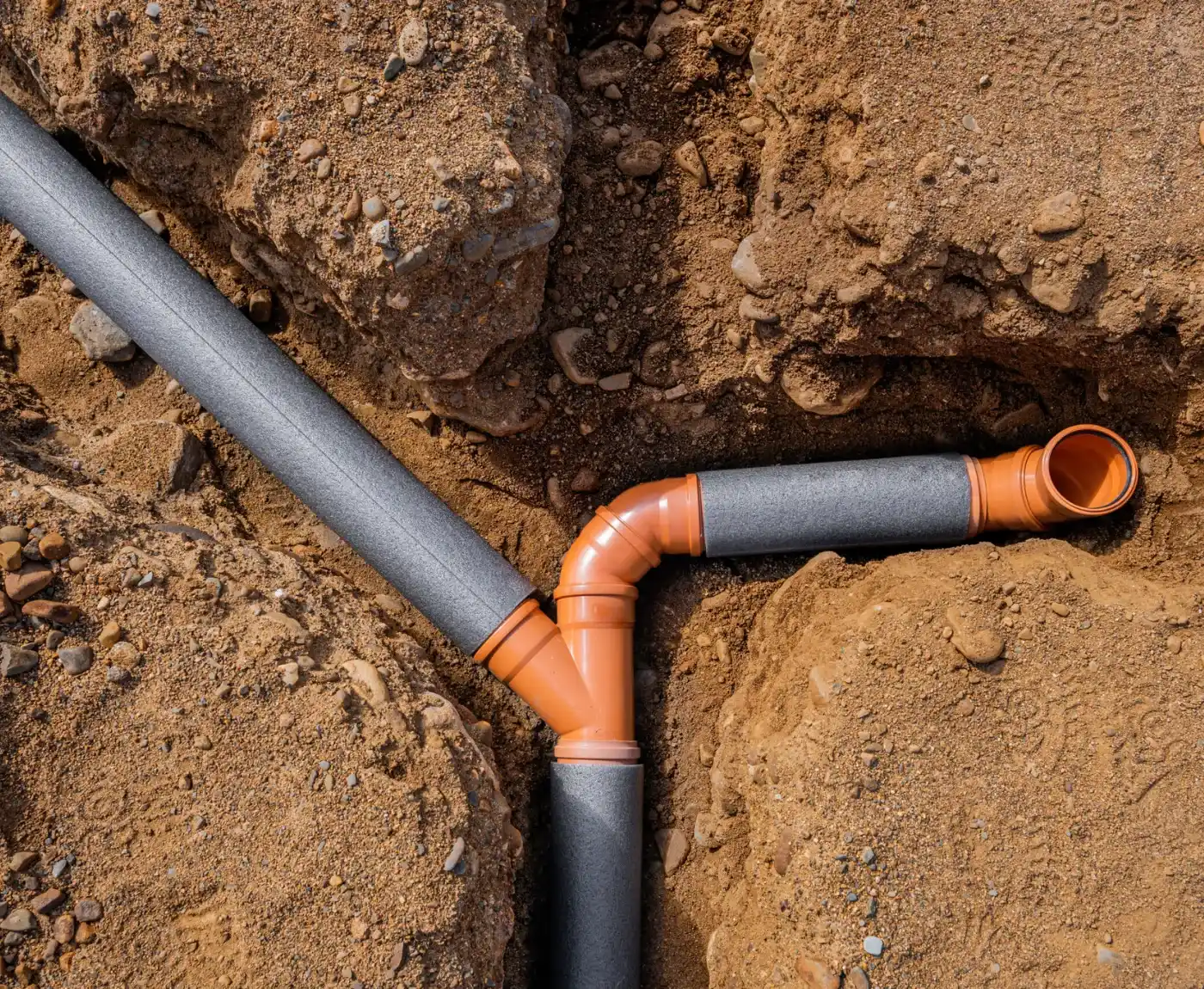 Engineers installing replacement drainage pipes during asbestos pipe replacement in Sussex.